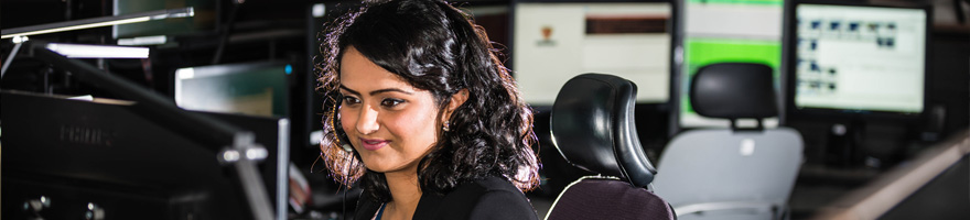 Female dispatcher sitting in front of computer