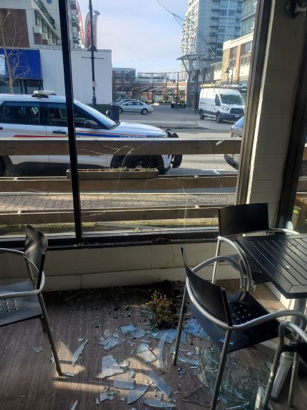 broken window and smashed glass litter the inside of business